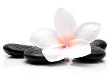Picture of a massage stones with a white flower on top