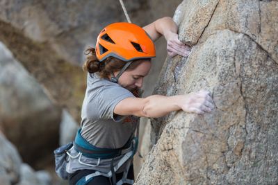 Picture of female adult climbing a rock